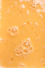 Fresh beaten eggs with bubbles as food background