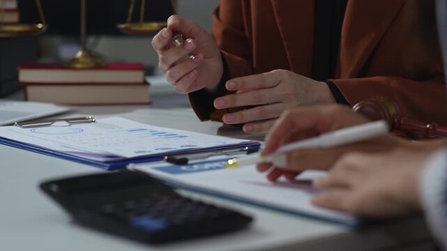 Lawyers and business professionals discuss contract papers at the office. legal and corporate consultation concept focusing on law, advice, and business agreements.
