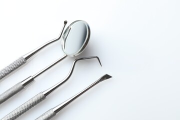Different dental tools on white table, closeup. Space for text