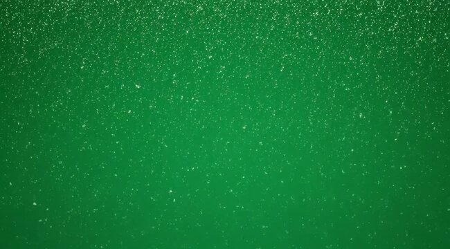 Vibrant green background with sparkling particles moving dynamically