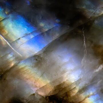 Moonstone (Rainbow) macro, adularescence effect, glowing blue and rainbow sheen on a milky white stone surface