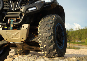A man engages in extreme ATV riding on sand beach early in the morning