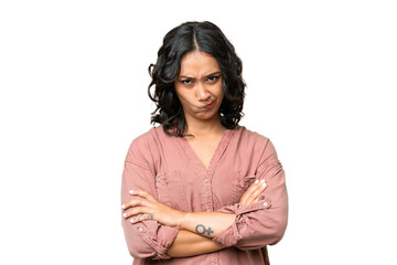 Young Argentinian woman over isolated background with unhappy expression