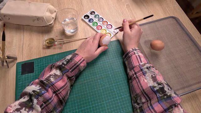POV. woman coloring Easter eggs preparing to holiday at home. DIY work.