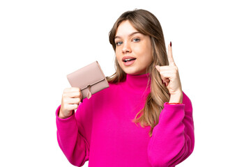 Naklejka premium Young girl holding a wallet over isolated chroma key background pointing up a great idea