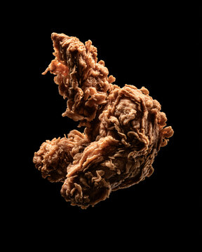 A close-up isolated shot of brown, twisted, fibrous root vegetable