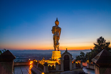 4. The golden Buddha statue at Wat Khao Noi welcomes the sunrise, symbolizing faith, tranquility, and the cultural heritage of Nan.