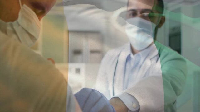 Patient rolling sleeve, gloved provider injecting vaccine while green or white or orange overlay dri