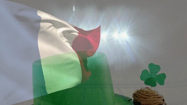 Flag filling frame and waving, cueing green hat rising, revealing cupcake and shamrock for promo
