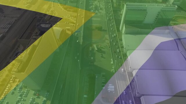 Aerial pan starting, South African flag sweeping and fading to reveal coastal port traffic