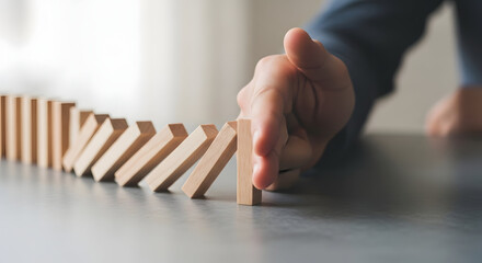 Conceptual Close-up Domino Effect Stopping Hand Action Sequence Image