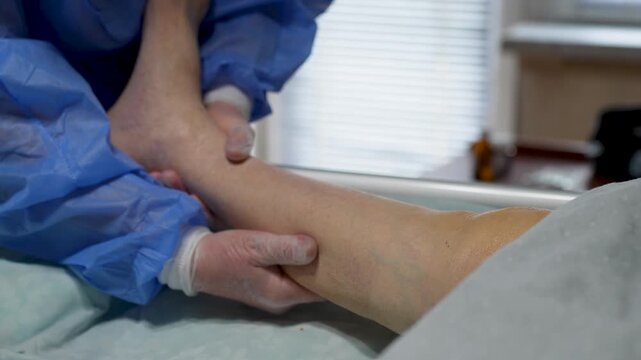 Medical Foot Massage and Joint Mobilization. Close-up of a medical professional performing manual therapy and therapeutic massage on a patient foot. Elderly care, caregiving and nursing