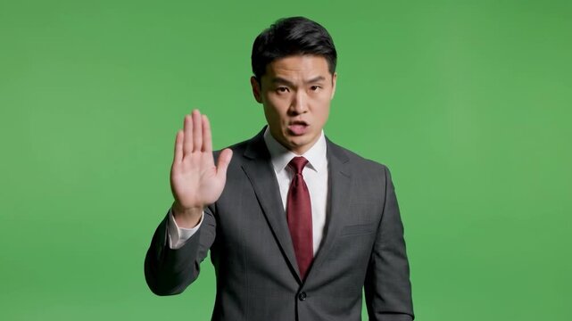 A serious businessman gestures emphatically, communicating strong disapproval. Ideal for illustrating conflict, objection, or assertive communication 
