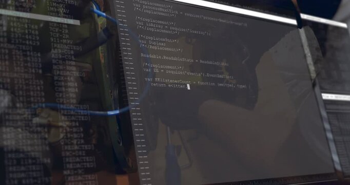 Mechanic at workbench adjusting flywheel while terminal scrolling code, guiding repair and testing