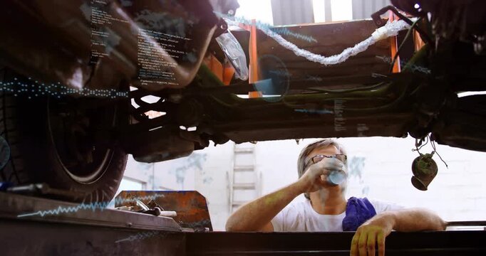 Tech emerging from lift taking sips and inspecting auto chassis with code overlays showing struts