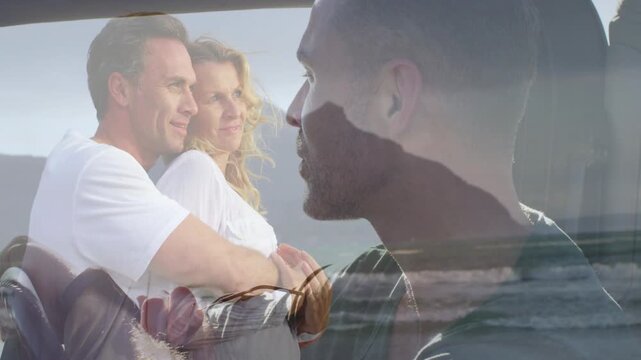 Profile man holding while crossfading revealing seated couple embracing and ocean, aiding marketing