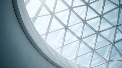 Fototapeta premium Looking up at a glass dome ceiling, geometric steel structure, bright natural light