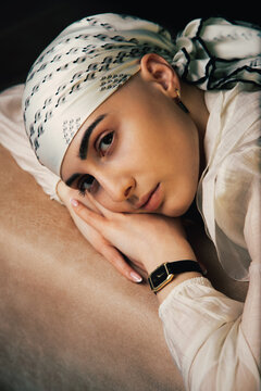 Portrait of a bald young woman with natural beauty and confident expression, isolated on neutral background. Concept of individuality, strength, self-acceptance, awareness, alopecia,