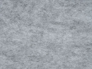 Fototapeta premium Soft grey felt. Surface of felted fabric texture abstract background in gray color. Pattern for text, lettering, patch work or other art work. Full frame backdrop wallpaper. High resolution photo.