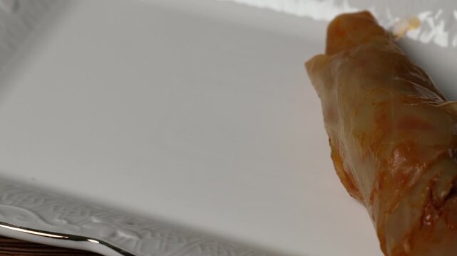 Cook puts cabbage rolls on a plate 4k video