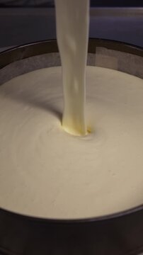 The process of making sponge cake. The concept of making confectionery desserts. The pastry chef applies the cream to the cakes.