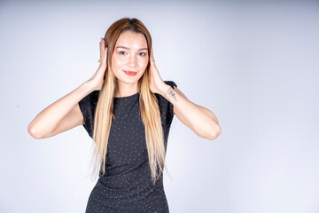 The model is making a sign that she can't hear.