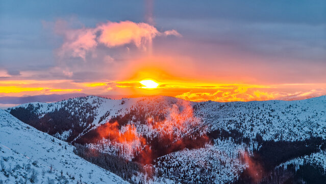 Breathtaking golden hour sunset illuminating majestic snow-capped mountains in Chopk mountains