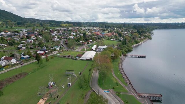 Aerial view of lakeside town center with pier, park and waterfront promenade. Lago Ranco, Chile