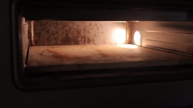 Close-up of hands scoring bread dough before baking and placing it into a oven. Artisan baking process, homemade bread preparation, traditional bakery concept in a domestic kitchen