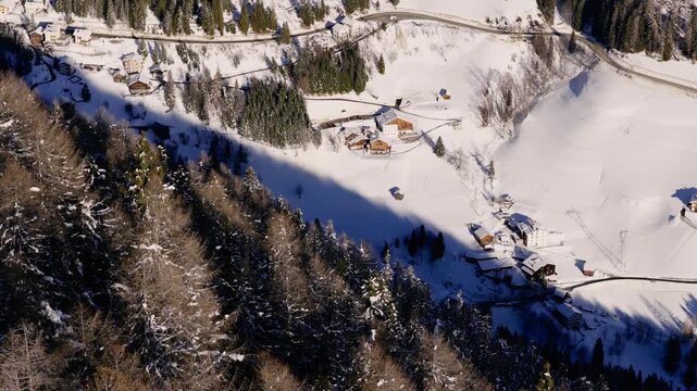 Aerial View Of Pine Tree Forest And Arabba Ski Resort In The Italian Dolomites.