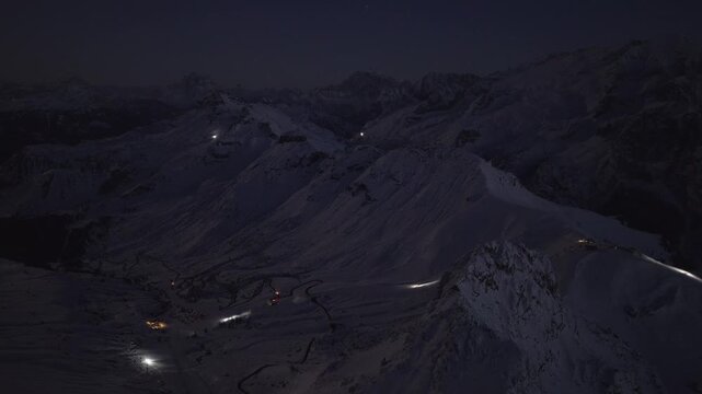Snow Groomers Working On The Ski Resort At Night In Sass Pordoi, Dolomites, Italy. - aerial shot
