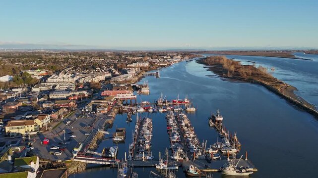 Drone flies over Steveston Harbour reavling baots and traffic on raodway