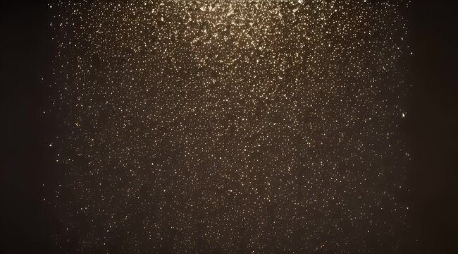 Abstract background with golden glittering light particles falling from above on dark