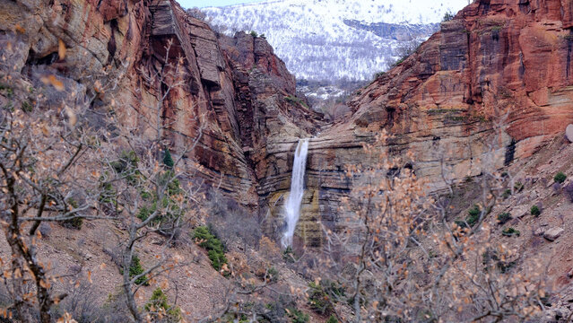 Newe Waterfall Cascading Through Red Canyon Cliffs in Winter, Tunceli Turkey