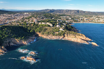 Fototapeta premium Aerial view of Sant Feliu de Guíxols and Mediterranean coastline on sunny day. Girona, Spain.