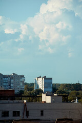 Multi-story buildings in the distance beyond the rooftops of other buildings in the city