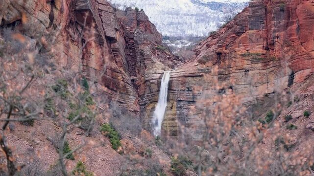 Scenic Mountain Waterfall Flowing Through Red Rock Canyon in Winter