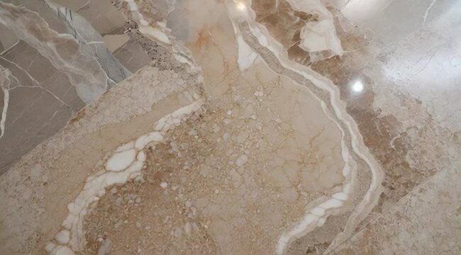 Natural marble flooring with intricate patterns and earthy tones  