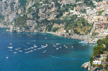 Obraz premium Numerous boats anchored in turquoise water along the rugged cliffs of the Amalfi Coast, Salerno, Campania, Italy, Europe