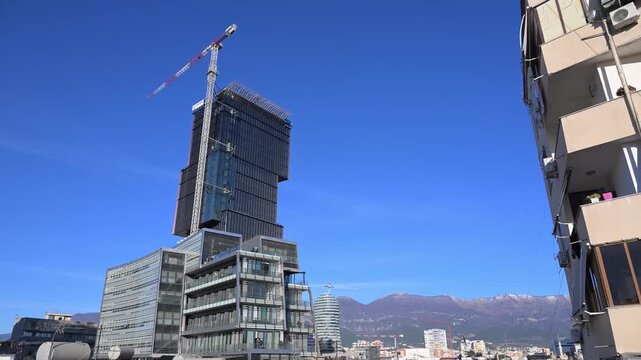 A modern mixed use skyscraper featuring four staggered cubic volumes and eye shaped glass atria that create a sculptural silhouette near the central pedestrian plaza