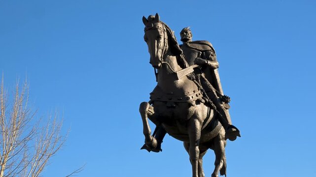 A majestic bronze sculpture of the national hero Gjergj Kastrioti Skanderbeg on horseback presiding over the expansive stone pedestrian plaza within the heart of the metropolitan center