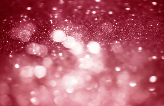 Pink, red white glittering Christmas lights. Blurred abstract bokeh background.