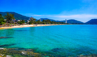 Tropical Patong Kamala Beach Phuket Thailand tourists people parasol palm. © Arkadi
