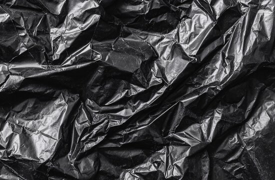 Black crumpled plastic sheet showing textured surface