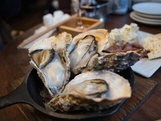 スキレットに盛り付けた焼き牡蠣（殻付き・ビストロ風）