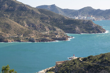 Obraz premium The coastal landscape of Spain, featuring the town of Cartagena, with its historic fortifications and the vibrant blue waters of the Mediterranean Sea