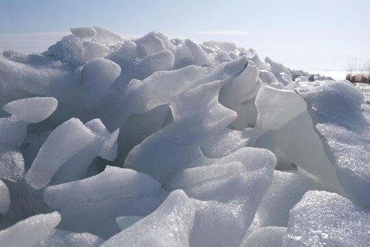 Piled ice on the shore of Baltic Sea in Puck Bay in early spring day. Oslonino, Pomerania, Poland