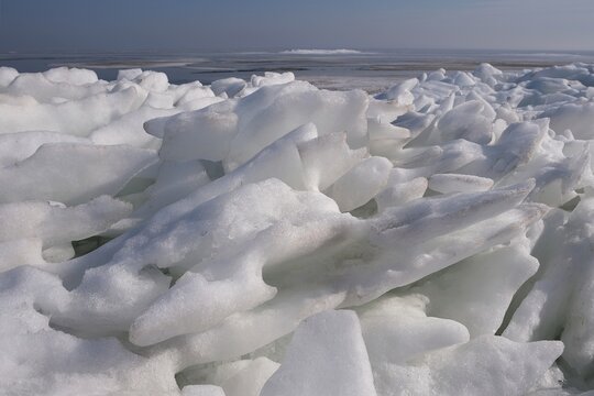Piled ice on the shore of Baltic Sea in Puck Bay in early spring day. Oslonino, Pomerania, Poland