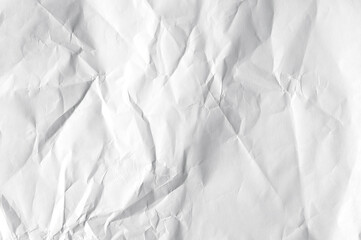 Fototapeta premium Crumpled white blank sheet as texture or background, long picture of folded paper, top view