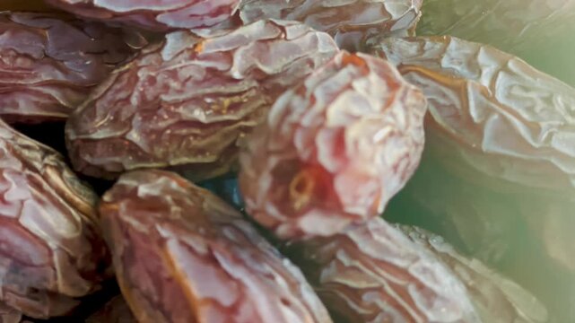 Close-up video of dates, sweet dried dates with a rich chocolate texture.